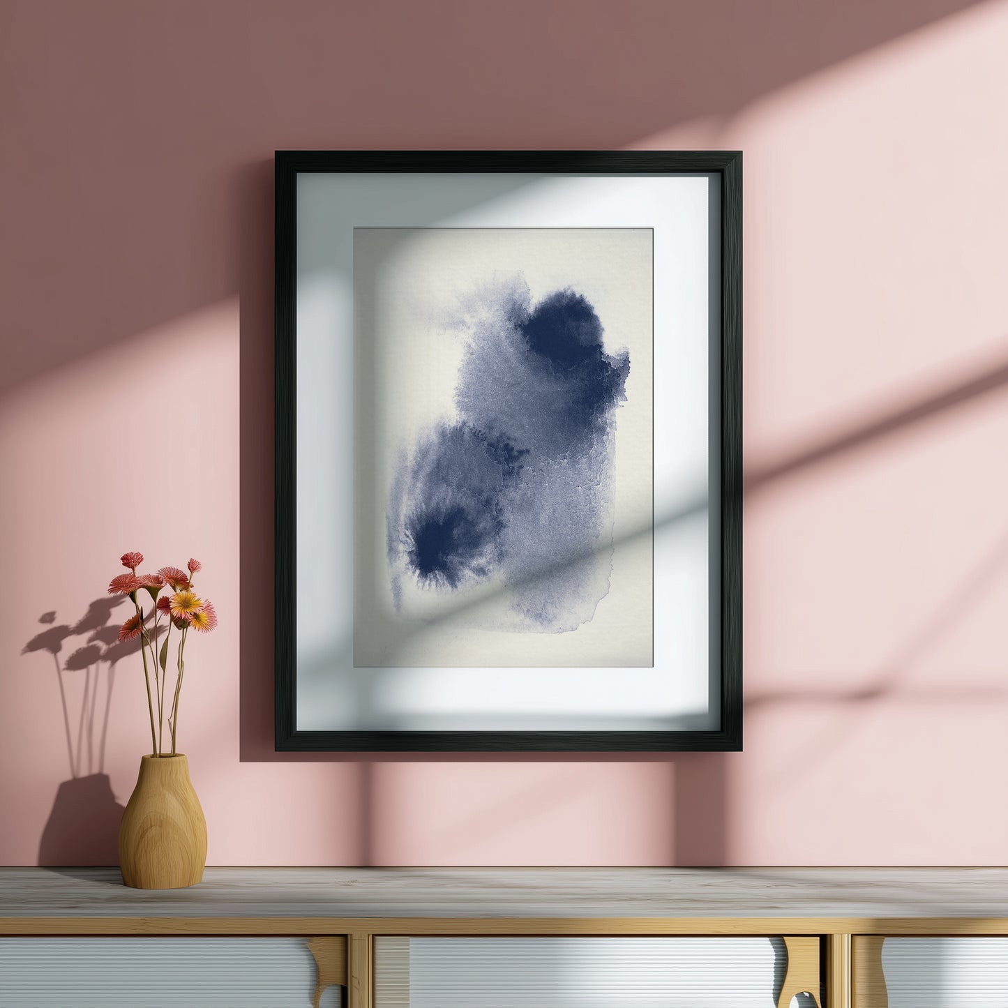 Blue abstract art piece on a pink wall.