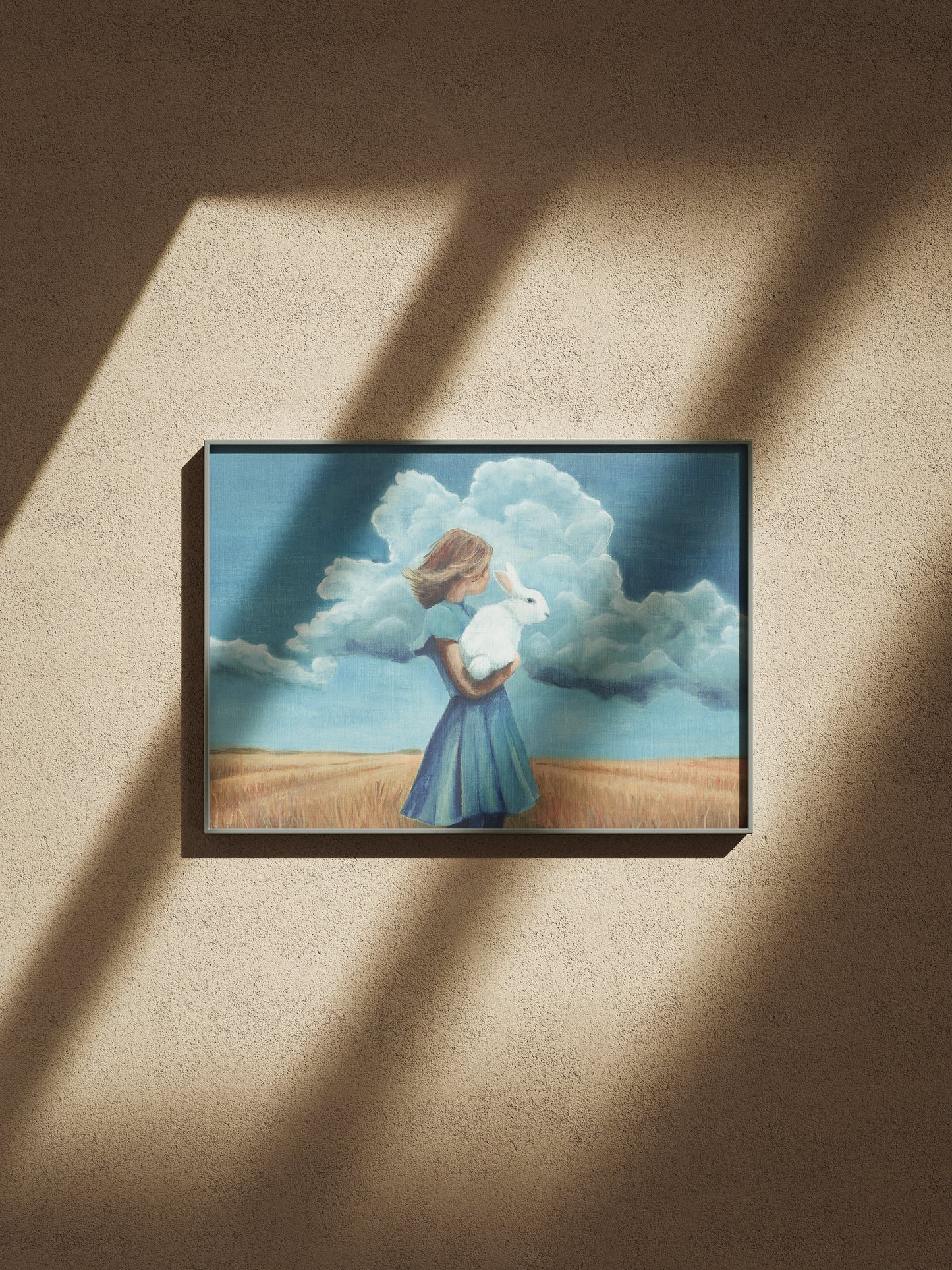 a woman holding a rabbit with a blue sky background on a beige wall.