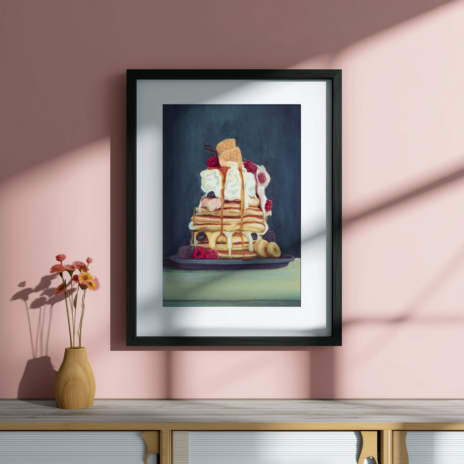 colourful stack of pancakes on a pink wall 