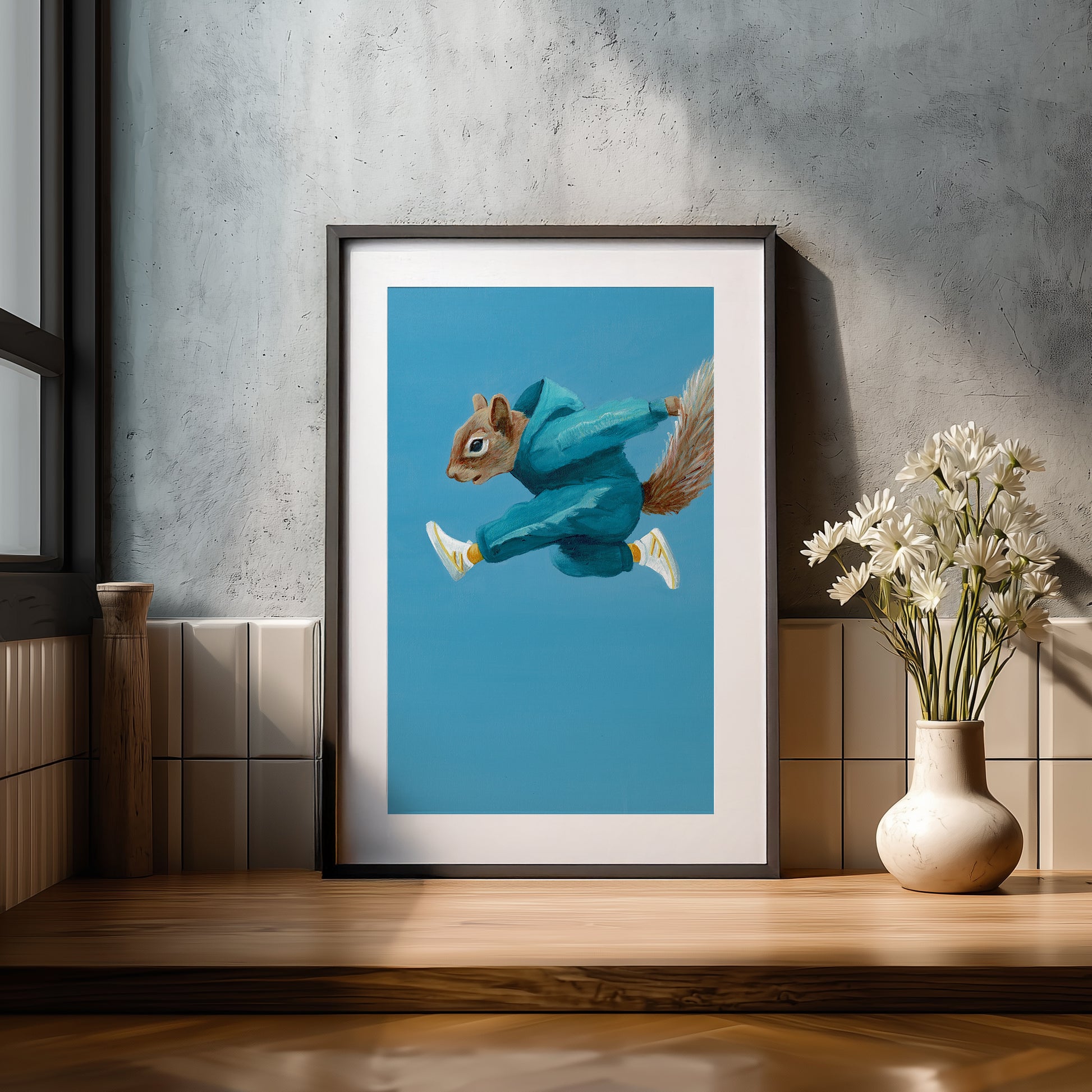 Framed artwork of a squirrel in a blue hoodie.