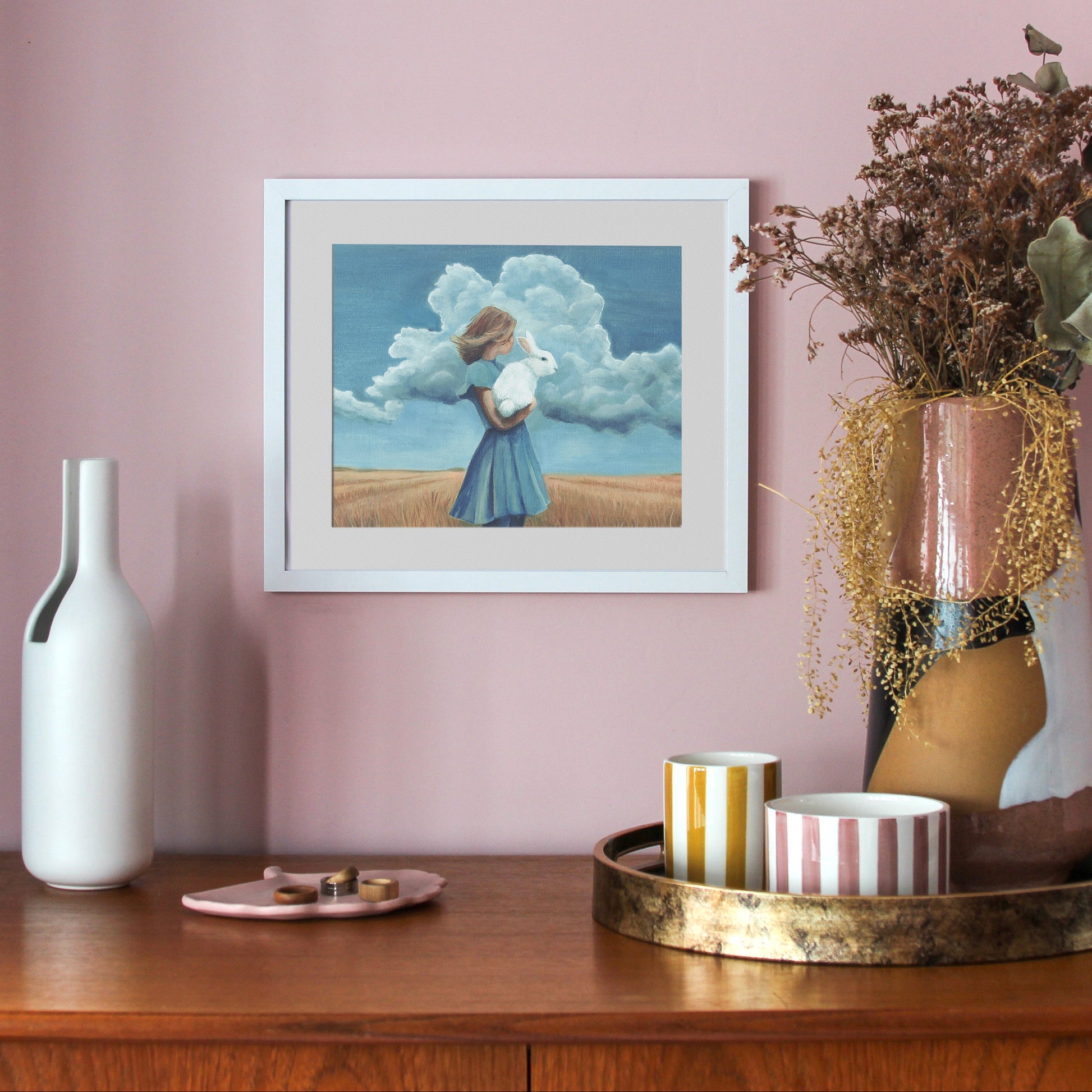 woman standing in a field holding a white rabbit, alice in wonderland, the wizard of oz
