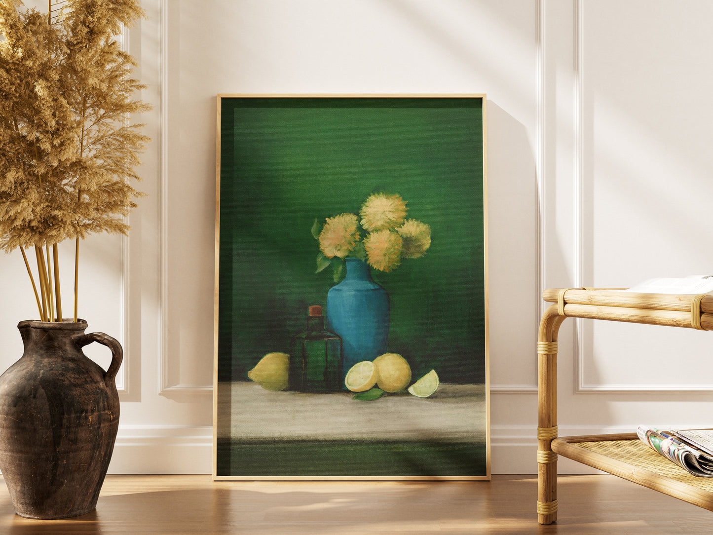 Framed painting of a still life scene with a blue vase and flowers, placed on a table.