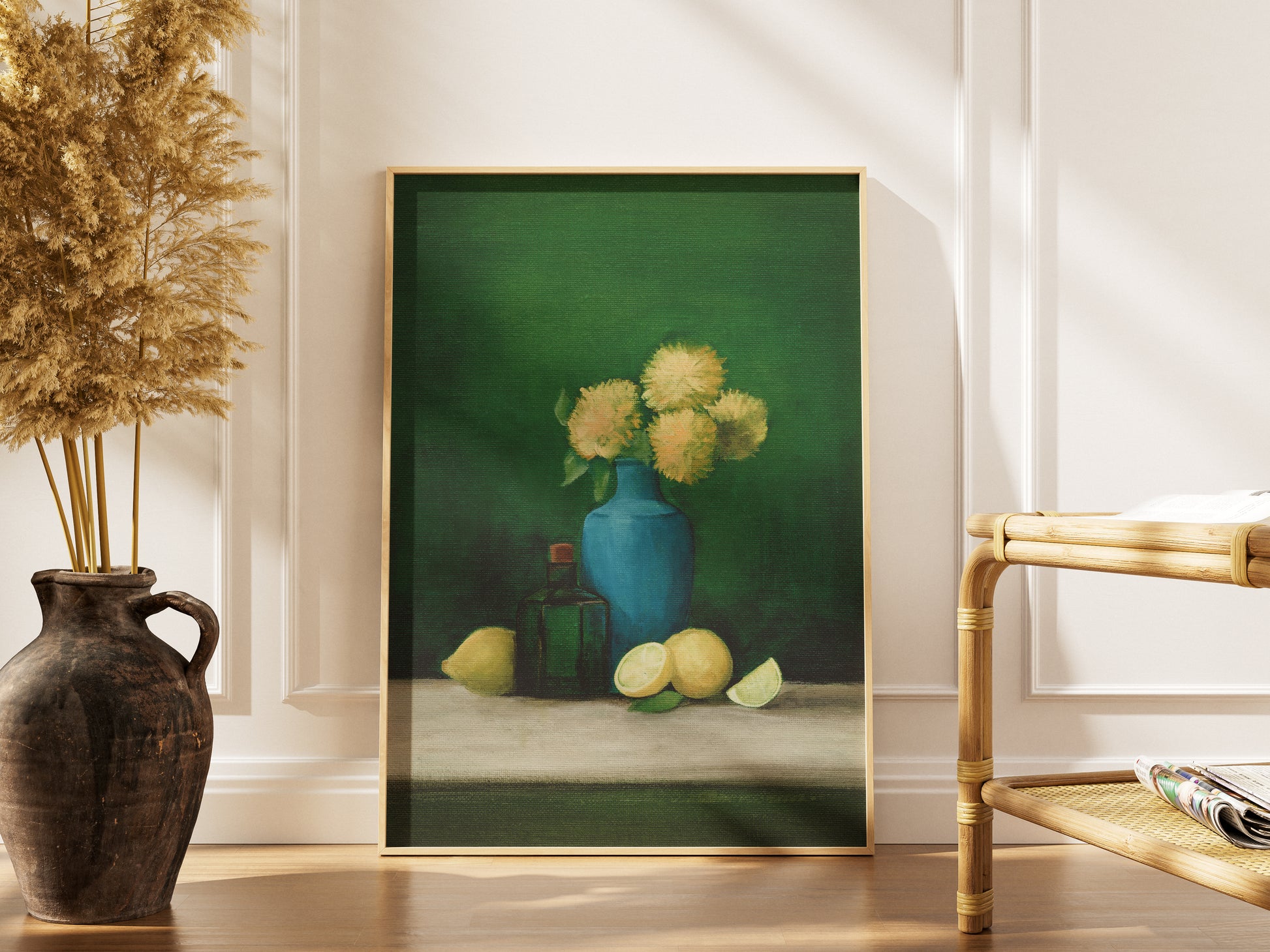 Framed painting of a still life scene with a blue vase and flowers, placed on a table.